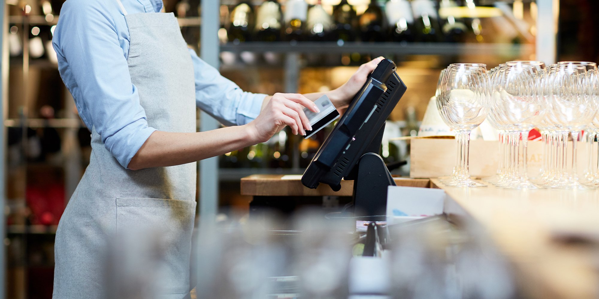 Close-up of waitress closing out orders at the cash desk.